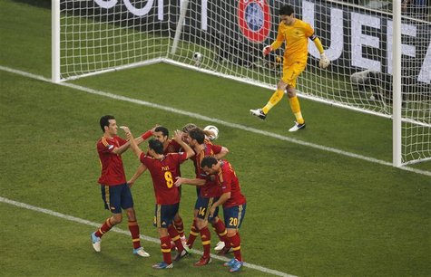 Spain's players celebrate their second goal next to France's goalkeeper Hugo Lloris during their Euro 2012 quarter-final soccer match at the Spain's players celebrate their second goal next to France's goalkeeper Hugo Lloris during their Euro 2012 quarter-final soccer match at the