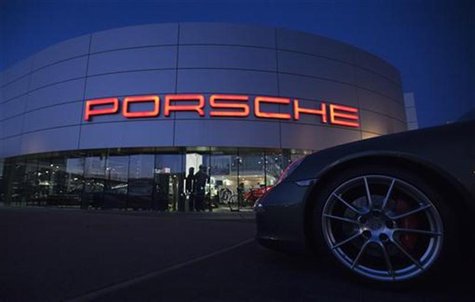 An illuminated Porsche logo is pictured on a building of a Porsche retail centre in Niederwangen, outside Bern March 9, 2012. REUTERS/Michae An illuminated Porsche logo is pictured on a building of a Porsche retail centre in Niederwangen, outside Bern March 9, 2012. REUTERS/Michae