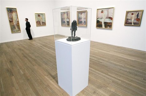 Duncan Holden of the Tate poses with all six paintings of Edvard Munch's "Weeping Woman" series, and a sculpture with the same name, at the Duncan Holden of the Tate poses with all six paintings of Edvard Munch's "Weeping Woman" series, and a sculpture with the same name, at the