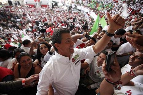 Enrique Pena Nieto, presidential candidate of the opposition Institutional Revolutionary Party (PRI), is cheered by supporters during a rall Enrique Pena Nieto, presidential candidate of the opposition Institutional Revolutionary Party (PRI), is cheered by supporters during a rall
