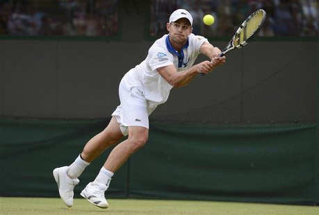 Andy Roddick of the U.S. hits a return to Jamie Baker of Britain during their men's singles tennis match at the Wimbledon tennis championshi Andy Roddick of the U.S. hits a return to Jamie Baker of Britain during their men's singles tennis match at the Wimbledon tennis championshi