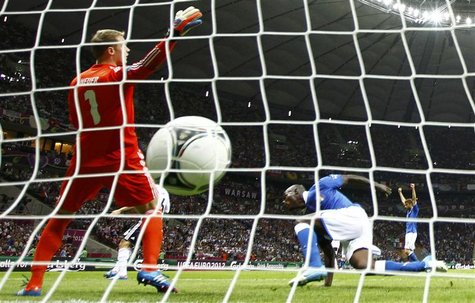 Italy's Mario Balotelli (R) scores a goal against Germany's goalkeeper Manuel Neuer during their Euro 2012 semi-final soccer match at the Na Italy's Mario Balotelli (R) scores a goal against Germany's goalkeeper Manuel Neuer during their Euro 2012 semi-final soccer match at the Na