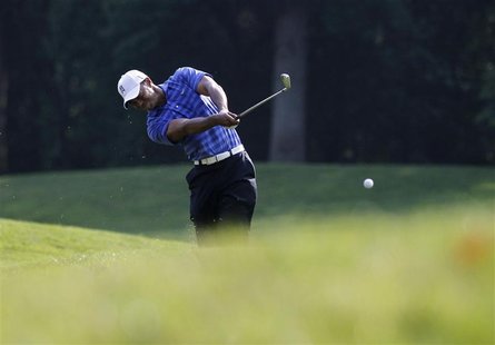Tiger Woods of the U.S. plays his second shot on the 14th hole during the second round of the AT&T National golf tournament in Bethesda, Mar Tiger Woods of the U.S. plays his second shot on the 14th hole during the second round of the AT&T National golf tournament in Bethesda, Mar