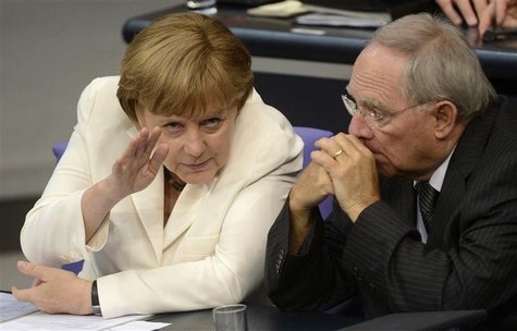 German Chancellor Angela Merkel (L) talks with her Finance Minister Wolfgang Schaeuble before the vote for ratification of the European Unio German Chancellor Angela Merkel (L) talks with her Finance Minister Wolfgang Schaeuble before the vote for ratification of the European Unio