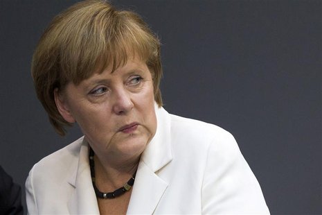 German Chancellor Angela Merkel looks on before delivering a government policy statement in the German lower house of parliament, the Bundes German Chancellor Angela Merkel looks on before delivering a government policy statement in the German lower house of parliament, the Bundes