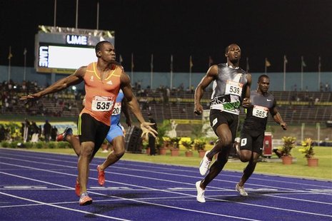 Yohan Blake (L) and Usain Bolt (front R) cross the finish line during their men's 100 meters final event at the Jamaican Olympic trials in K Yohan Blake (L) and Usain Bolt (front R) cross the finish line during their men's 100 meters final event at the Jamaican Olympic trials in K