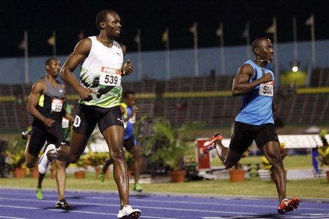 Usain Bolt (L) crosses the finish line during the men's 200 meters semi-final event at the Jamaican Olympic trials in Kingston city, June 30 Usain Bolt (L) crosses the finish line during the men's 200 meters semi-final event at the Jamaican Olympic trials in Kingston city, June 30