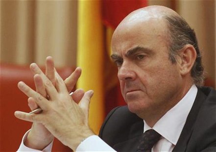 Spain's Economy Minister Luis de Guindos listens to a question during a parliamentary hearing at the Spanish parliament in Madrid June 26, 2 Spain's Economy Minister Luis de Guindos listens to a question during a parliamentary hearing at the Spanish parliament in Madrid June 26, 2