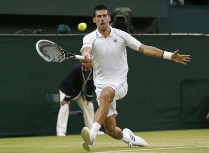 Novak Djokovic of Serbia hits a return to Viktor Troicki of Serbia during their men's singles tennis match at the Wimbledon tennis champions Novak Djokovic of Serbia hits a return to Viktor Troicki of Serbia during their men's singles tennis match at the Wimbledon tennis champions