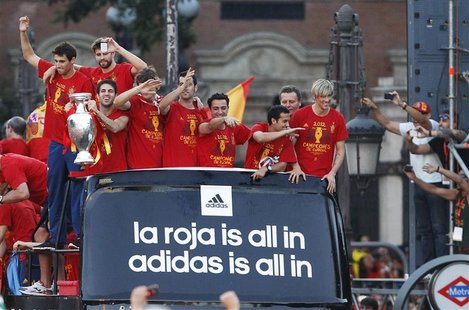 Spain's national soccer team players celebrate their Euro 2012 victory on an open top bus during a parade in downtown Madrid July 2, 2012. S Spain's national soccer team players celebrate their Euro 2012 victory on an open top bus during a parade in downtown Madrid July 2, 2012. S