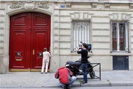 Journalists stand in front of the entrance of a building housing the new offices of former French President Nicolas Sarkozy in Paris July 3, Journalists stand in front of the entrance of a building housing the new offices of former French President Nicolas Sarkozy in Paris July 3,