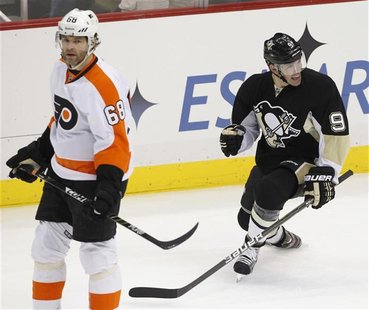 Pittsburgh Penguins' Pascal Dupuis (9) celebrates his goal behind Philadelphia Flyers' Jaromir Jagr (68) in the first period of their NHL ho Pittsburgh Penguins' Pascal Dupuis (9) celebrates his goal behind Philadelphia Flyers' Jaromir Jagr (68) in the first period of their NHL ho