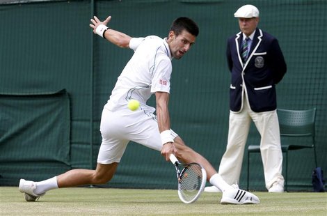 Novak Djokovic of Serbia hits a return to Florian Mayer of Germany during their men's quarter-final tennis match at the Wimbledon tennis cha Novak Djokovic of Serbia hits a return to Florian Mayer of Germany during their men's quarter-final tennis match at the Wimbledon tennis cha