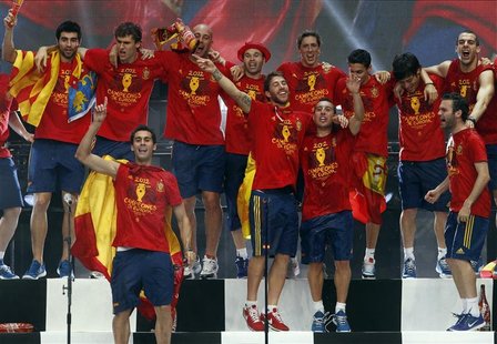 Spain's national soccer team players celebrate their Euro 2012 victory on a stage in downtown Madrid July 2, 2012. REUTERS/Andrea Comas Spain's national soccer team players celebrate their Euro 2012 victory on a stage in downtown Madrid July 2, 2012. REUTERS/Andrea Comas