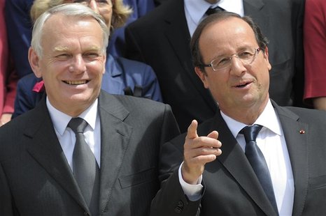France's President Francois Hollande (R) and Prime Minister Jean-Marc Ayrault pose for the traditional family photo of the government after France's President Francois Hollande (R) and Prime Minister Jean-Marc Ayrault pose for the traditional family photo of the government after