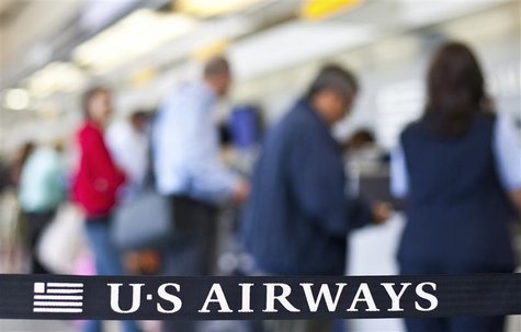 US Airways passengers check in for their flights at Charlotte Douglas International Airport in Charlotte, North Carolina April 20, 2012. REU US Airways passengers check in for their flights at Charlotte Douglas International Airport in Charlotte, North Carolina April 20, 2012. REU