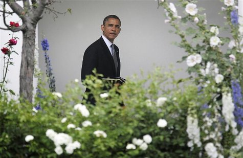 U.S. President Barack Obama walks from the Oval Office to the residence as he departs for a day trip to Ohio and New York, from the White Ho U.S. President Barack Obama walks from the Oval Office to the residence as he departs for a day trip to Ohio and New York, from the White Ho