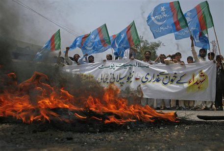 Supporters of Islami Jamiat Talaba, a student wing of Pakistan religious and political party Jamaat-e-Islami, hold their party flags as they Supporters of Islami Jamiat Talaba, a student wing of Pakistan religious and political party Jamaat-e-Islami, hold their party flags as they