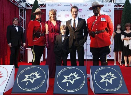 Actor Eric McCormack poses with his star on the red carpet with his wife Janet Leigh Holden and his son Finnigan during the 13th annual Cana Actor Eric McCormack poses with his star on the red carpet with his wife Janet Leigh Holden and his son Finnigan during the 13th annual Cana