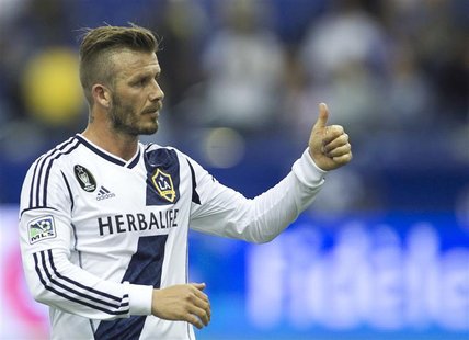 LA Galaxy's David Beckham gestures to the crowds following the end of their MLS soccer match against the Montreal Impact in Montreal, Quebec LA Galaxy's David Beckham gestures to the crowds following the end of their MLS soccer match against the Montreal Impact in Montreal, Quebec