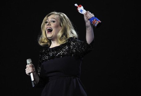 Adele reacts as she holds her award for best British album of the year during the BRIT Music Awards at the O2 Arena in London February 21, 2 Adele reacts as she holds her award for best British album of the year during the BRIT Music Awards at the O2 Arena in London February 21, 2
