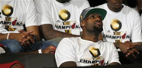 Miami Heat player LeBron James looks around on stage at a rally in Miami, Florida June 25, 2012. REUTERS/Andrew Innerarity Miami Heat player LeBron James looks around on stage at a rally in Miami, Florida June 25, 2012. REUTERS/Andrew Innerarity