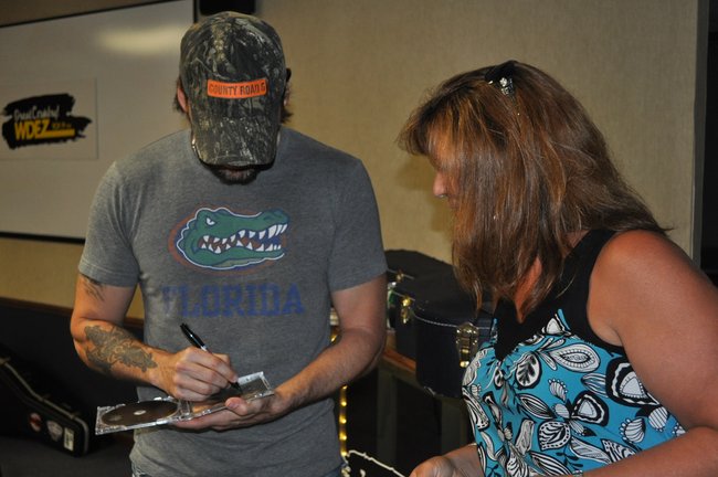 Rick Monroe signs CDs for listeners