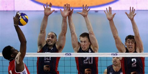Wilfredo Leon (L) of Cuba spikes the ball against Clayton Stanley (2nd L), David Smith and Sean Rooney (R) of the U.S. during their FIVB Wor Wilfredo Leon (L) of Cuba spikes the ball against Clayton Stanley (2nd L), David Smith and Sean Rooney (R) of the U.S. during their FIVB Wor