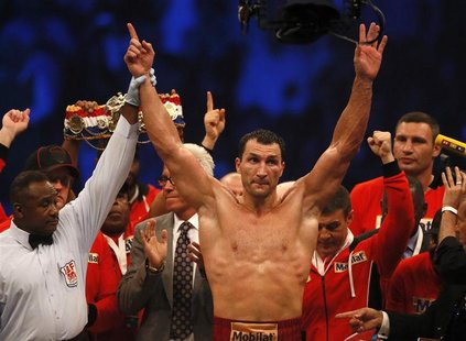 Title holder Vladimir Klitschko of Ukraine (C) celebrates next to his brother Vitali (R) after defeating contender Tony Thompson of the U.S. Title holder Vladimir Klitschko of Ukraine (C) celebrates next to his brother Vitali (R) after defeating contender Tony Thompson of the U.S.