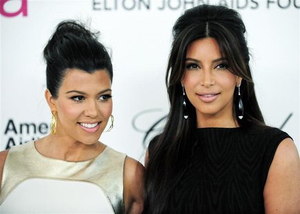 Television personalities sisters Kourtney and Kim Kardashian (R) arrive at the 20th annual Elton John AIDS Foundation Academy Awards Viewing Television personalities sisters Kourtney and Kim Kardashian (R) arrive at the 20th annual Elton John AIDS Foundation Academy Awards Viewing