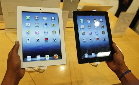 A man inspects the Apple New iPad (L) next to an iPad 2 at an electronics store in Mumbai April 27, 2012. REUTERS/Vivek Prakash A man inspects the Apple New iPad (L) next to an iPad 2 at an electronics store in Mumbai April 27, 2012. REUTERS/Vivek Prakash