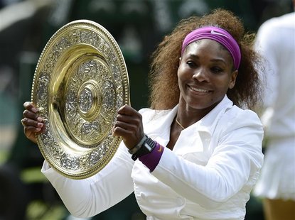 Serena Williams of the U.S. holds her trophy after defeating Agnieszka Radwanska of Poland in their women's final tennis match at the Wimble Serena Williams of the U.S. holds her trophy after defeating Agnieszka Radwanska of Poland in their women's final tennis match at the Wimble