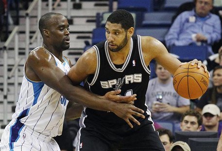 San Antonio Spurs center Tim Duncan (R) works against New Orleans Hornets center Emeka Okafor during the first half of their NBA basketball San Antonio Spurs center Tim Duncan (R) works against New Orleans Hornets center Emeka Okafor during the first half of their NBA basketball