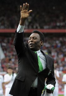 New York Cosmos's honorary president Pele salutes the crowd ahead of Manchester United's Paul Scholes' testimonial soccer match in Mancheste New York Cosmos's honorary president Pele salutes the crowd ahead of Manchester United's Paul Scholes' testimonial soccer match in Mancheste