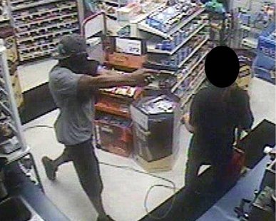 An armed robber points a gun at a clerk in the Family Fare gas station on Washington Ave. around 10:30 PM on July 12, 2012. (photo courtesy Holland Dept. of Public Safety) An armed robber points a gun at a clerk in the Family Fare gas station on Washington Ave. around 10:30 PM on July 12, 2012. (photo courtesy Holland Dept. of Public Safety)