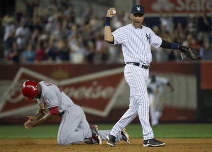 New York Yankees shortstop Derek Jeter and Los Angeles Angels runner Howard Kendrick (L) react after Jeter caught Kendrick trying to steal s New York Yankees shortstop Derek Jeter and Los Angeles Angels runner Howard Kendrick (L) react after Jeter caught Kendrick trying to steal s