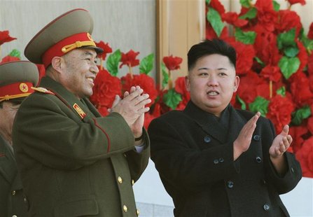 North Korean leader Kim Jong-Un (R) exchanges smiles with Ri Yong-ho during a military parade to mark the birth anniversary of the North's l North Korean leader Kim Jong-Un (R) exchanges smiles with Ri Yong-ho during a military parade to mark the birth anniversary of the North's l
