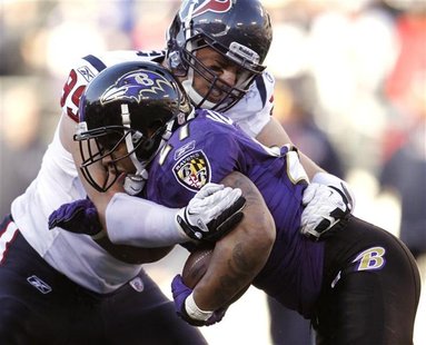Baltimore Ravens running back Ray Rice (lower) is tackled by Houston Texans defensive end J.J. Watt during their NFL AFC Divisional playoff Baltimore Ravens running back Ray Rice (lower) is tackled by Houston Texans defensive end J.J. Watt during their NFL AFC Divisional playoff