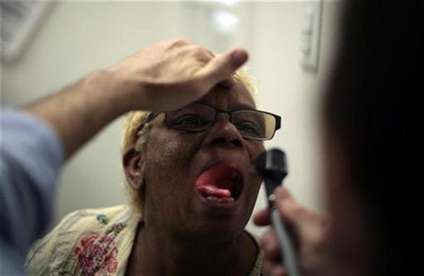 Rachel Lowe, 50, has her throat examined as part of a street medicine program between Venice Family Clinic and St Joseph Homeless Day Center Rachel Lowe, 50, has her throat examined as part of a street medicine program between Venice Family Clinic and St Joseph Homeless Day Center
