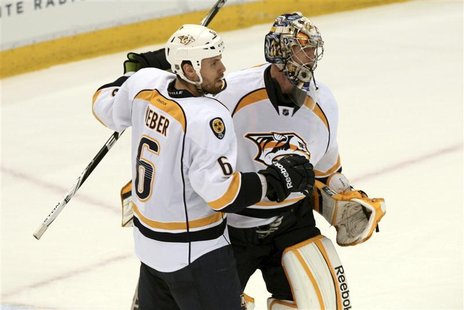 Nashville Predators defenseman Shea Weber (L) celebrates their victory over the Detroit Red Wings with Predators goalie Pekka Rinne during t Nashville Predators defenseman Shea Weber (L) celebrates their victory over the Detroit Red Wings with Predators goalie Pekka Rinne during t