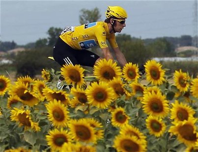 Sky Procycling rider and leader's yellow jersey Bradley Wiggins of Britain cycles past sunflowers during the 18th stage of the 99th Tour de Sky Procycling rider and leader's yellow jersey Bradley Wiggins of Britain cycles past sunflowers during the 18th stage of the 99th Tour de