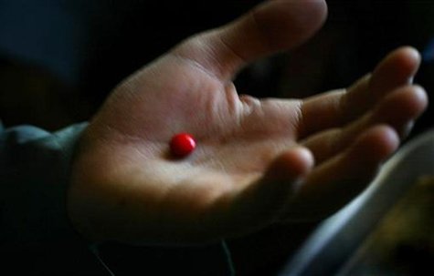 A malnourished boy holds an iron supplement pill in his palm before swallowing it at a supplementary feeding clinic in Kohistan, about 50 km A malnourished boy holds an iron supplement pill in his palm before swallowing it at a supplementary feeding clinic in Kohistan, about 50 km