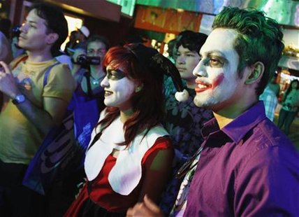 People, dressed as characters from Batman movies, pose while waiting for the midnight premiere of "The Dark Knight Rises", the final install People, dressed as characters from Batman movies, pose while waiting for the midnight premiere of "The Dark Knight Rises", the final install