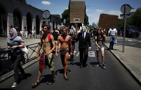 Demonstrators wearing Guy Fawkes masks march outside the Spanish Labour Ministry during an unemployment protest in Madrid July 21, 2012. REU Demonstrators wearing Guy Fawkes masks march outside the Spanish Labour Ministry during an unemployment protest in Madrid July 21, 2012. REU