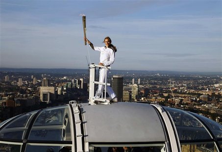Torch bearer Amelia Hempleman-Adams, age 17, stands on top of a capsule on the London Eye as part of the torch relay ahead of the London 201 Torch bearer Amelia Hempleman-Adams, age 17, stands on top of a capsule on the London Eye as part of the torch relay ahead of the London 201