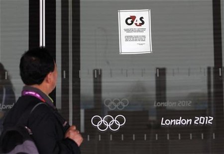A visitor to the Olympic Park reads a 4GS notice stuck to a window at the Aquatics centre, in the Olympic Park, in Stratford, east London, J A visitor to the Olympic Park reads a 4GS notice stuck to a window at the Aquatics centre, in the Olympic Park, in Stratford, east London, J