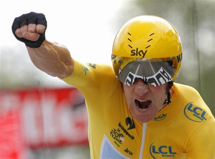 Sky Procycling rider and leader's yellow jersey Bradley Wiggins of Britain holds up his arm as he crosses the finish line during the individ Sky Procycling rider and leader's yellow jersey Bradley Wiggins of Britain holds up his arm as he crosses the finish line during the individ