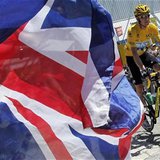 Sky Procycling rider and leader's yellow jersey Bradley Wiggins of Britain cycles past a British flag as he prepares to start before the ele