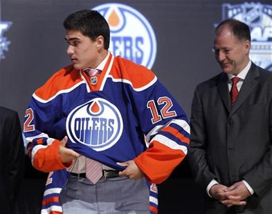 Nail Yakupov puts on his new jersey after being picked by the Edmonton
