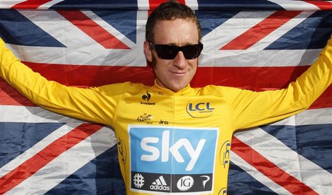 Sky Procycling rider and leader's yellow jersey Bradley Wiggins of Britain celebrates with a British national flag on the Champs Elysees aft Sky Procycling rider and leader's yellow jersey Bradley Wiggins of Britain celebrates with a British national flag on the Champs Elysees aft